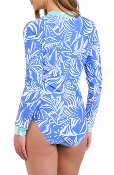 A tropical print brings sunny-day vibrance to this half-zip rashguard that protects you from the harsher elements of the sun and sea. Half-zip closure Crewneck Long sleeves 83% nylon, 17% elastane Hand wash, line dry Imported Blue Beachwear Rash Guard For Vacation, Spring Vacation Beachwear Rash Guard, Spring Beachwear Rash Guard For Pool, Printed Rash Guard For Surfing Beachwear, Long Sleeve Printed Rash Guard For Beach, Printed Rash Guard For Beach Season Surfing, Printed Long Sleeve Rash Guard For Beach, Fitted Printed Rash Guard For Poolside, Printed Rash Guard For Surfing In Beach Season