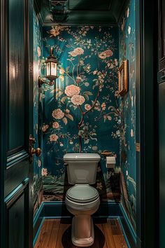 a toilet in a bathroom with floral wallpaper on the walls and wood flooring