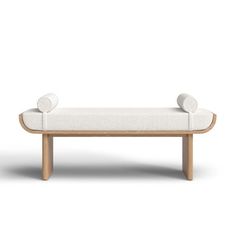 a white couch with two pillows on it's back and one arm extended to the side