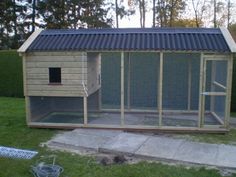 a chicken coop in the middle of a yard