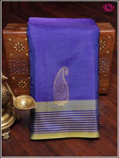 A bananapith silk saree in blue and yellow showcases a delightful fusion of colors. The fabric's luxurious texture elevates the appeal, while mango motifs intricately woven in the body and pallu add a touch of traditional charm. The addition of a striped border enhances the elegance, creating a balanced and visually appealing ensemble. This type of saree is perfect for those seeking an elegant and sustainable fashion choice. Hand-woven saree. Fall & pico - done Tassels on pallu Blouse piece - no Elegant Blouse Designs, Blue And Yellow, Blouse Piece, Silk Saree, Blouse Designs, Silk Sarees, Hand Woven, Sustainable Fashion, Tassels