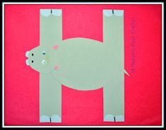 the letter h is made out of paper with a polar bear on it's back