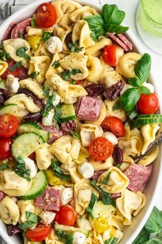 a bowl filled with pasta salad on top of a table