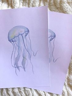 two watercolor paintings of jellyfish on purple paper