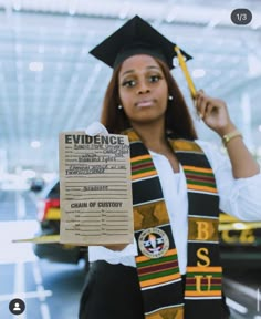 a woman wearing a graduation cap and gown holding up a paper with the words evidence on it