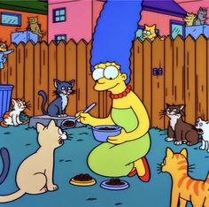 the simpsons character is cooking in her backyard with many cats around him and she has blue hair