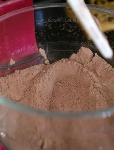 a bowl filled with chocolate powder and a spoon