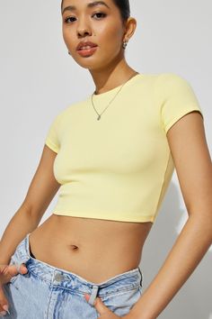 A softer-than-soft fitted baby tee in a cropped length. Features - Short sleeves - Classic crew neck Size & Fit - Fitted, stretch ribbed knit - Cropped length (hits above the belly button) Materials & Care - 56% cotton, 38% rayon, 6% spandex - Machine wash, cold - Imported Beige T Shirt, Beige T Shirts, Yellow Crop Top, Yellow Blouse, Short Sleeve Cropped Top, Knit Crop Top, Shirt Short Sleeve, Knit Crop, Infant Tees