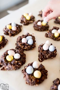 someone is decorating cookies with chocolate and eggs on them for an easter party or brunch