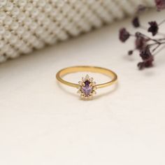 Discover the timeless elegance of our 14K solid gold drop ring, featuring a mesmerizing amethyst--the birthstone for February--accented by exquisite diamonds. This handcrafted ring marries luxury with durability, using only the highest quality materials to ensure a piece that can be treasured for generations. The perfect choice for anyone born in February, the deep purple amethyst is not only beautiful but also said to bring clarity and calm to its wearer. Crafted in solid 14K gold, this ring is designed to withstand the everyday without losing its lavish appeal. The central amethyst stone is carefully selected for its deep color and clarity, cradled by a halo of sparkling diamonds that extend down the sides of the ring. This piece is available in a range of sizes and can also be customize Valentine's Day 14k Gold Birthstone Jewelry, 14k Gold Amethyst Birthstone Ring, Round Cut, Elegant Heart-shaped Amethyst Ring Gift, Heart-shaped Amethyst Birthstone Ring As A Gift, Heart-shaped Amethyst Ring With Center Stone For Gift, February Birthstone Jewelry, Born In February, Drop Ring, Handcrafted Rings