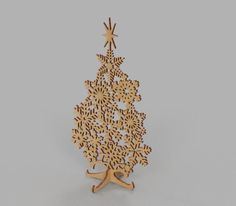 a wooden christmas tree with snowflakes hanging from it's sides and an ornament in the shape of a star