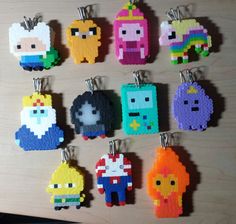 a bunch of pixel key chains hanging on a wall