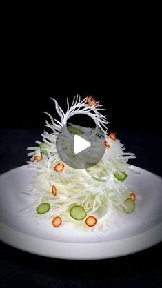 a white plate topped with vegetables on top of a black table