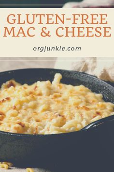 a skillet filled with macaroni and cheese on top of a wooden table