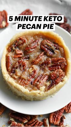 pecan pie on a white plate surrounded by pecans