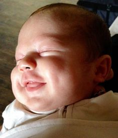 a close up of a baby with its eyes closed