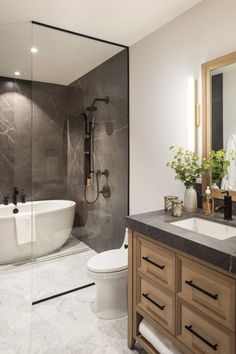 a bathroom with a tub, toilet and sink in it's centerpieces