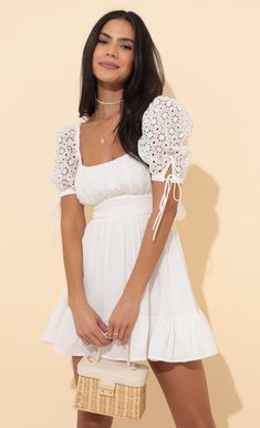 Strut your stuff in this oh so adorable princess dress. The Shay will have all eyes on you due to the lace puff sleeves, square neckline and flared skirt. Made in our white chiffon fabric. Pair with white sneakers or nude heels for a day to night look we are loving. 
	 
	Made in Los Angeles
	 
	- 100% Polyester 
	- Fully Lined 
	- Hand Wash Cold 
	 
	Length of Dress 31in/78.7cm 
	All Measurements Are For A Size Small Feminine Lace Puff Sleeve Dress For Summer, Chic Lace Puff Sleeve Dress For Summer, White Lace Puff Sleeve Dress For Spring, White Lace Puff Sleeve Dress With Lace Trim, White Puff Sleeve Dress With Ruffles For Brunch, White Puff Sleeve Mini Dress With Lace Trim, White Lace Puff Sleeve Elegant Dress, Elegant White Lace Puff Sleeve Dress, Cute White Puff Sleeve Dress For Brunch