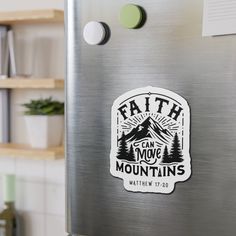 a sticker that says faith can move mountains on the side of a refrigerator door