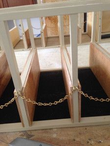 a cell phone sitting on top of a wooden floor next to a box with chains