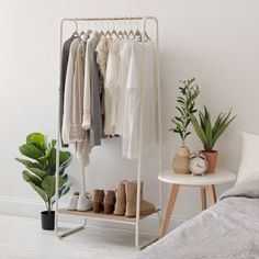 Clothing storage made easy. This metal garment rack with marble wood shelf provides a convenient closet solution for small spaces. The built-in wood shelf at the bottom is great for storing shoes or folded clothes, while the two foot wide closet rack gives you plenty of space to hang your clothes. Available in black or white frames with respective marble patterned wood board, you can mix and match the garment racks to create customizable closet organization to suit your needs. Compliant with CAR Closet Organizers & Garment Racks, Small Space Storage Solutions, Small Guest Room, Closet Rack, No Closet Solutions, Garment Rack, Small Space Storage, Metal Clothing, Storage Closet Organization