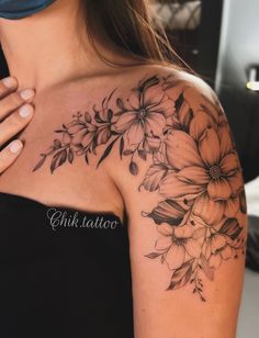 a woman's shoulder with flowers on it