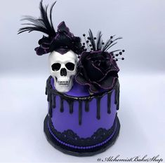 a purple and black cake with a skull on top