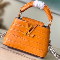 The noble crocodile leather pattern has been polished and shines charmingly. The luxurious goatskin lining and sparkling metal accessories. The unique Capucines Yhl cover can be stored in the bag to display the letters. The logo can be turned outwards to reveal the Monogram Flower pattern.

Size: 16*11*6.5cm Louis Vuitton Orange, Louis Vuitton Yayoi Kusama, Crocodile Handbags, Louis Vuitton Capucines, Large Cosmetic Bag, Lv Purse, Lv Shoes, Medium Handbags, Louis Vuitton Pochette