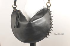 Spiky Halfmoon. Mini bag. Italian leather handbag of first choice. Black color. The peculiarity of this bag are the applied leather tips that make punk an extremely classic accessory. Double seams everywhere. The measurements are: height about 24 cm (about 9,44 inches), width zipper side about 38 cm (about 14,9 inches). The strap can be worn in two sizes: in its length or shortened by passing the hook into the opposite ring and attach it in the starting ring. The length of the strap is basic abo Edgy Leather Bags For Concerts, Gothic Leather Bags With Rivets, Punk Leather Bags With Rivets, Edgy Everyday Bags With Rivets, Leather Bags With Rivets For Alternative Fashion, Gothic Leather Shoulder Bag For Daily Use, Punk Leather Bag For Festivals, Leather Bag With Rivets For Concerts, Gothic Leather Bag For Everyday Use