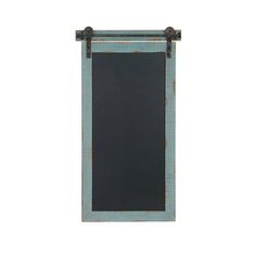 a chalkboard hanging on the side of a wall with an iron frame and metal fittings