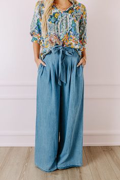 - Go with this flow in these trendy pants! - Unlined chambray material - A waistline with an elastic back, belt loops, and a removable tie closure belt - Pleated details on front - Functional side pockets - A relaxed silhouette that ends in wide floor length hemlines Trendy Denim Belted Bottoms, Trendy Belted Bottoms In Medium Wash, Trendy Belted Medium Wash Bottoms, Trendy Medium Wash Belted Bottoms, Belted Denim Blue Bottoms In Denim, Casual Belted Bottoms In Denim Blue, Belted High Waist Dark Wash Bottoms, Belted Denim Blue Bottoms, Chic Belted Denim Blue Bottoms