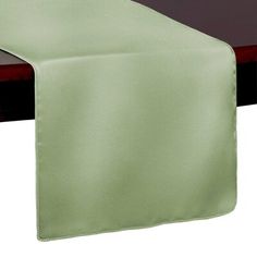 a green table runner on top of a wooden table