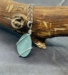 This delicate handcrafted seaglass pendant is made with a beautifully smoothed light teal blue nugget found in Kintyre on the west coast of Scotland. The glass is wrapped in 1mm 925 sterling  silver wire and is suspended from a hand-formed silver bail.   Choose your preferred chain length at checkout.      Other similar items available: Pendants: https://www.etsy.com/uk/shop/RockLobsterCrafts?ref=l2-shopheader-name&section_id=24274610 Bangles & bracelets:  https://www.etsy.com/uk/shop/RockLobste Wire Wrapped Sea Glass Jewelry Gift, Wire Wrapped Sea Glass Jewelry For Gifts, Turquoise Recycled Glass Jewelry For Jewelry Making, Turquoise Recycled Glass Jewelry For Crafting, Adjustable Wire Wrapped Necklace In Recycled Glass, Adjustable Wire Wrapped Necklaces In Recycled Glass, Unique Handmade Sea Glass Necklaces, Turquoise Wire Wrapped Sea Glass Jewelry, Turquoise Sea Glass Wire Wrapped Jewelry