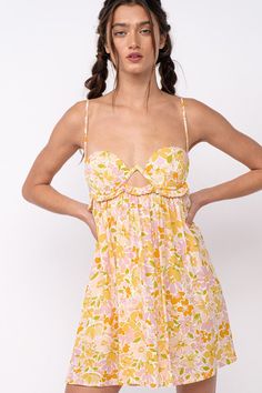 The Drew Peach Floral Babydoll Cami Mini Dress is here for sunshine and fun summer days! White, peach, and yellow floral fabric forms this cute floral bralette babydoll dress with cami straps and a bralette cutout bodice. The attached mini skirt falls from an empire waist. A ruffle back with ties finishes the look! Style with cute sandals for a fun summer look! DETAILS & CARE 100%Rayon. 100% Polyester Lining. Machine wash cold. Imported. ORDERS, SHIPPING & RETURNS Orders, Shipping, & Returns Spring Dresses With Built-in Bra For Brunch, Pink Mini Dress With Built-in Bra For Summer, Floral Print Sundress With Sweetheart Neckline For Spring, Spring Floral Print Sundress With Sweetheart Neckline, Spring Floral Sundress With Sweetheart Neckline, Floral Sundress With Sweetheart Neckline For Vacation, Spring Cotton Dress With Built-in Bra, Feminine Summer Sundress With Sweetheart Neckline, Spring Sundress With Spaghetti Straps And Built-in Bra