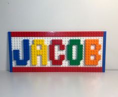 a lego sign with the word hope spelled in multicolored letters on it's side