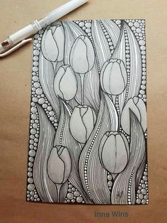 a drawing of tulips on a piece of paper next to a marker pen