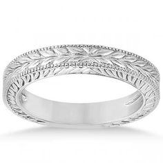 an engraved wedding band with leaves and scrolls on the sides, in white gold or silver