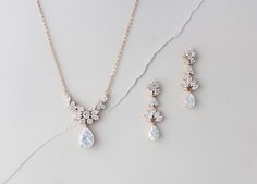 three pieces of jewelry on a white surface