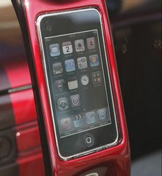 an iphone sitting in the center console of a car