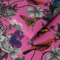 a pink wallpaper with colorful flowers and butterflies on it, next to a pair of scissors