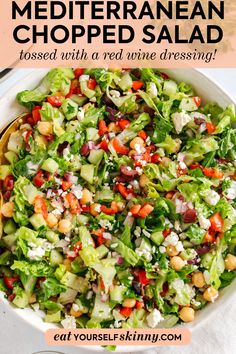 a salad in a bowl with text overlay that reads mediterranean chopped salad tossed with a red wine dressing