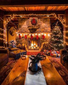 a living room filled with furniture and a fire place covered in christmas lights next to a fireplace