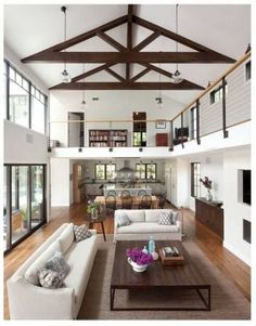 a living room filled with furniture and lots of windows