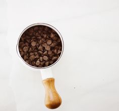 a wooden spoon with chocolate chips in it