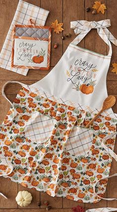 an apron and some pumpkins on a table