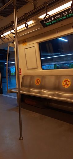 an empty subway car at night with its lights on and no people inside or out