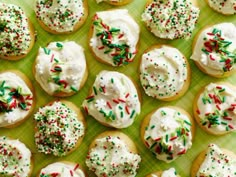 sprinkle covered cookies are on a baking sheet