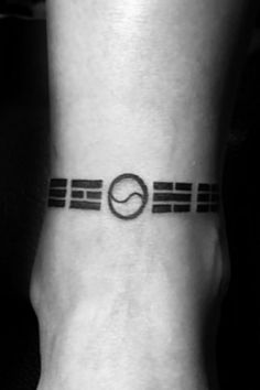 a black and white photo of a person's foot with a tattoo on it