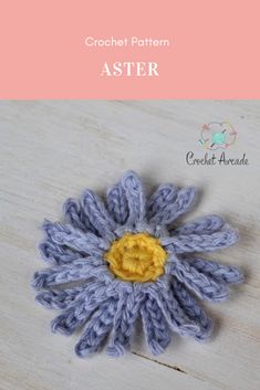 crochet pattern aster flower on wooden table with text overlay that reads,'crochet pattern aster '