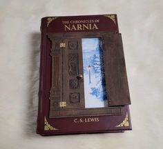 the book is opened to show an image of a snowy scene and it's cover